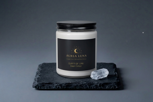 Clarity of Luna candle burning beside selenite in a midnight meditation setting — Áurea Luna
